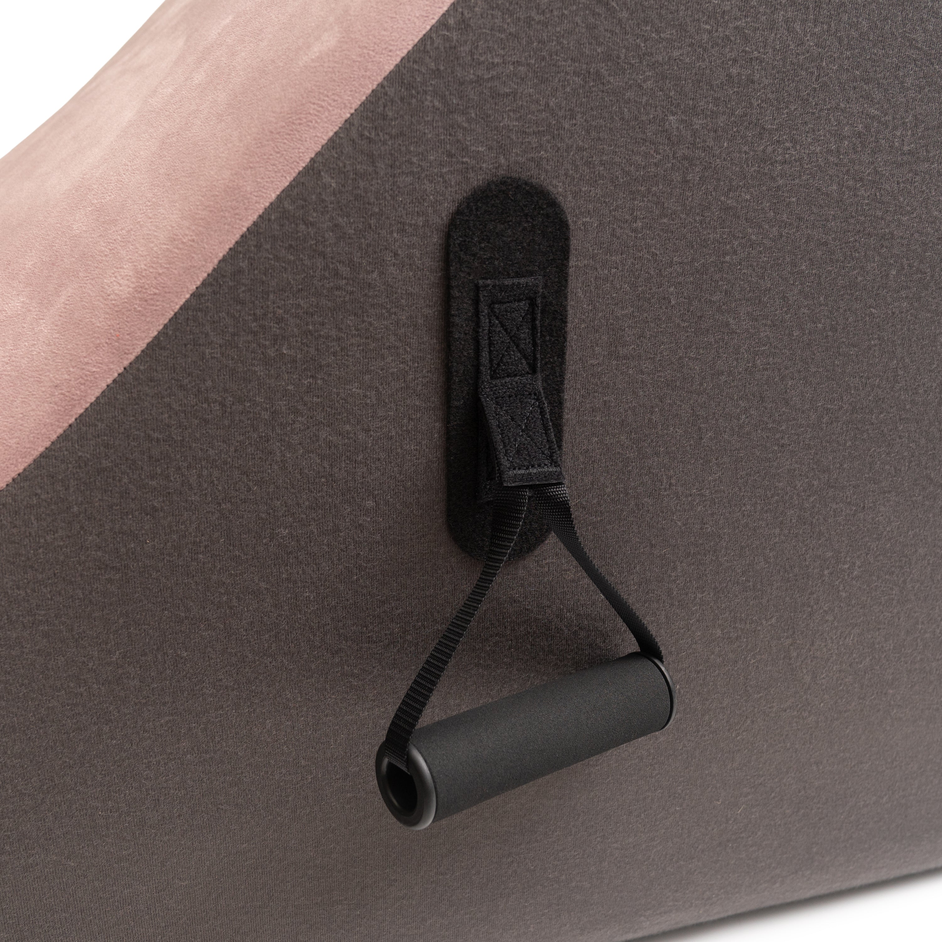 Black strap with clip attached to a gray surface