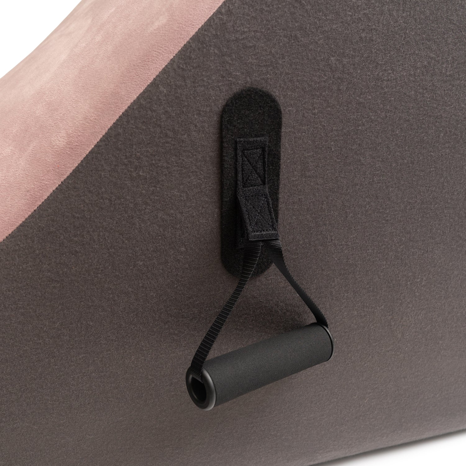 Black strap with clip attached to a gray surface