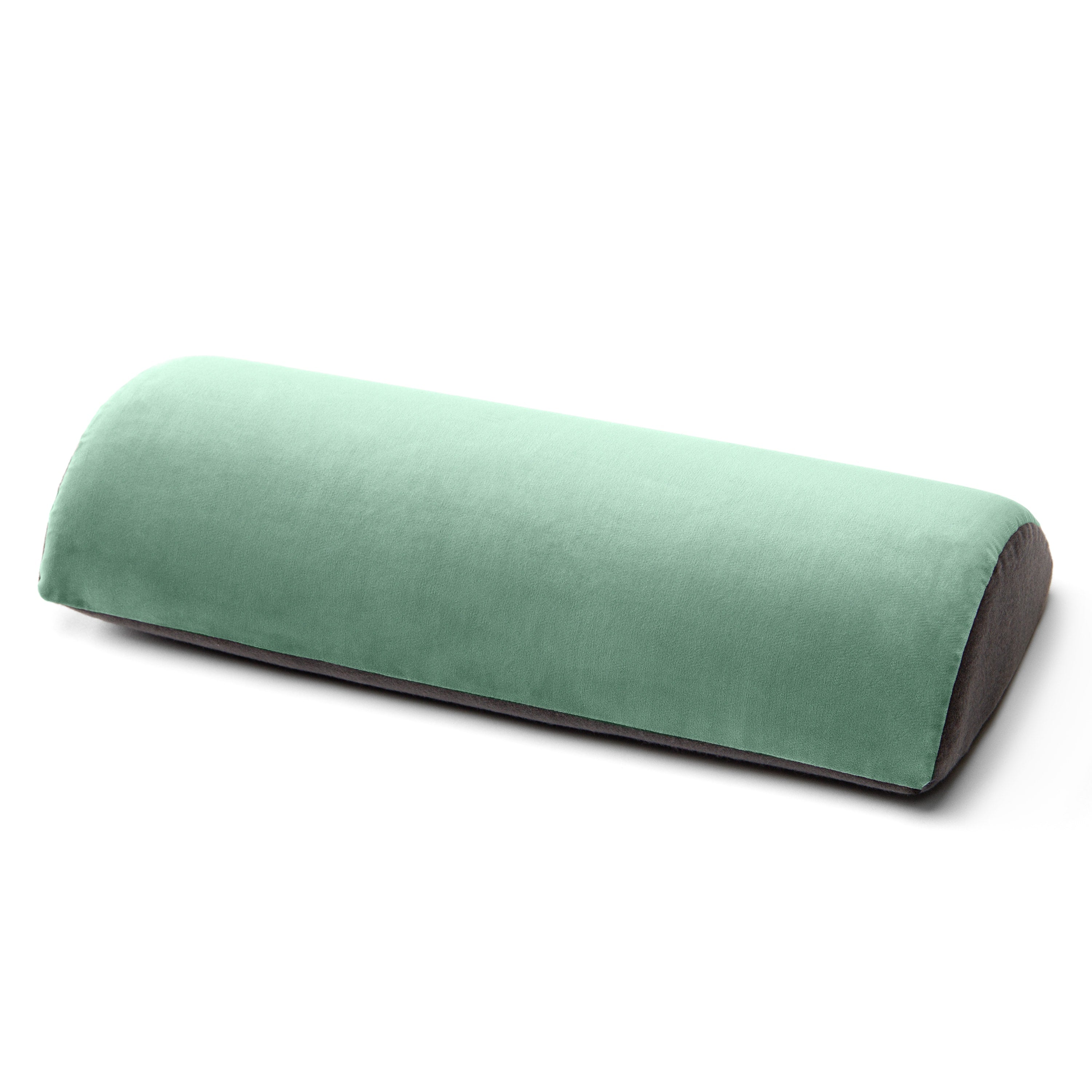 A curved lumbar support pillow in a light mint green velvet fabric with a dark brown underside, shown on a clean white background.