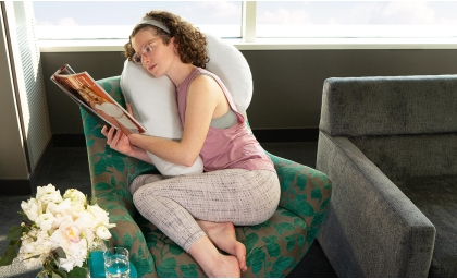 Model reading with Avana Uno Snuggle Pillow