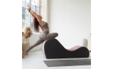 Woman doing yoga pose on Chakra Yoga Chaise in rose